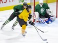 Team Gold's Luke Evangelista evades Team Green's Landon Sim in front of goalie Owen Flores during a scrimmage at the London Knights training camp at Budweiser Gardens on Monday Aug. 30, 2021. (Derek Ruttan/The London Free Press)