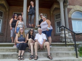 Executive director Chuck Lazenby, centre top, poses with staff and board members of the Unity Project at its location on Dundas Street on Aug. 11, 2021. (Mike Hensen/The London Free Press)