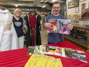 Carol Vandenberg and Gord Mood,  co-owners of L.A. Mood, get ready Wednesday, Aug. 11, 2021, for free comic book day Saturday in London. They will have cosplay outfits for photos as well as free comics to get new readers interested. (Mike Hensen/The London Free Press)