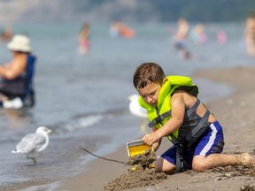 Amar Farhat, 4, plays on the main beach in Port Stanley on Monday. Farhat was there with his mom Dawn Hodgins at the start of what was to be a hot day. (Mike Hensen/The London Free Press)