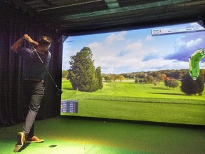 Derek Estabrooks drives the first hole of Bethpage Black at one of the new golf simulators in the Clubhouse, located at 100 Kellogg Lane in London. Photograph taken on Monday August 23, 2021. Mike Hensen/The London Free Press