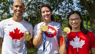 Damian Warner, Susanne Grainger, and Maggie Mac Neil show off their gold medals before the city celebrations for returning Olympians held in Labatt Park on Saturday August 28, 2021. 
Mike Hensen/The London Free Press/Postmedia Network