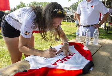 Susanne Grainger, who won a gold medal in the Women's eight, signs a supporters jacket before the city celebrations for returning Olympians held in Labatt Park on Saturday August 28, 2021. 
Mike Hensen/The London Free Press/Postmedia Network