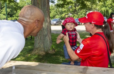 Damian Warner gets his son Theo to smile for photos with his partner Jen Cotten before the city celebrations for returning Olympians held in Labatt Park on Saturday August 28, 2021. 
Mike Hensen/The London Free Press/Postmedia Network