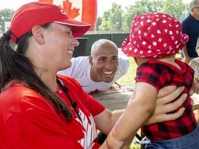 Damian Warner gets his son Theo to smile for photos with his partner Jen Cotten before the city celebrations for Summer Olympians, held in Labatt Park on Saturday August 28, 2021. Mike Hensen/The London Free Press/Postmedia Network
