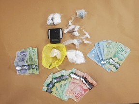 London police seized cash and illegal drugs worth more than $30,000 during a search Thursday of a property on King Street. Two men face drug trafficking charges. (Police supplied photo)