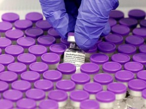 A health worker prepares a dose of the Pfizer-BioNtech COVID-19 vaccine at a large vaccination centre in this file photo.