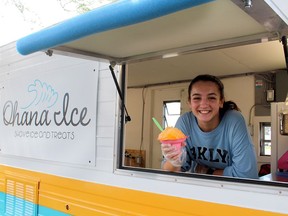 Maria Whittal, 14, owner of Ohana Ice and Treats, serves up flavoured shaved ice and candy floss from a trailer she helped convert in Chatham. (Ellwood Shreve/Chatham Daily News)