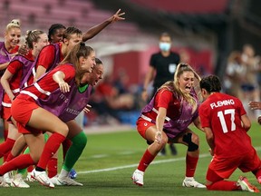 Jessie Fleming (17) is greeted by fellow Londoner Shelina Zadorsky and the rest of the Canadian women's soccer team after Fleming scored in the semifinal game against the U.S. at the Tokyo Olympics. Canada went on to win gold. (Photo by Naomi Baker/Getty Images)