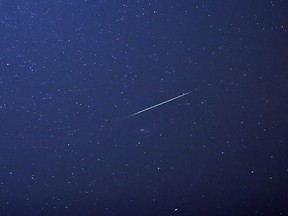 A falling star crosses the night sky over eastern Germany during the peak in activity of the annual Perseids meteor shower on August 13, 2015. (HENDRIK SCHMIDT/DPA/AFP via Getty Images)