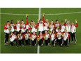 The gold medallist Canadian women's soccer team cheer their success during the medal ceremony at Olympic Stadium in Tokyo on Friday. (Carlos Barria/Reuters)