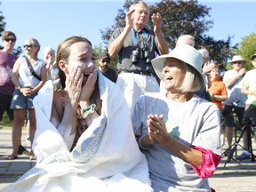 Transplant recipient Jillian Best of London is overcome with emotion after arriving Wednesday Aug. 4, 2021, at Marilyn Bell Park in Toronto, where she was hugged by her mom Bonnie. Best walked ashore at about 5:30 p.m. after swimming across Lake Ontario from Niagara-on-the-Lake to raise money to buy life-saving equipment for the organ transplant program at London Health Sciences Centre. on Wednesday August 4, 2021. (Jack Boland/Postmedia Network)