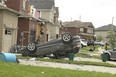 A tornado tore through a neighbourhood in the southeast end of Barrie on Thursday damaging at least 150 homes. A car is seen flipped on its roof on Majesty Blvd. on Friday July 16, 2021.