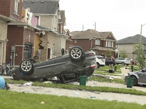 A tornado tore through a neighbourhood in the southeast end of Barrie on Thursday damaging at least 150 homes. A car is seen flipped on its roof on Majesty Blvd. on Friday July 16, 2021.