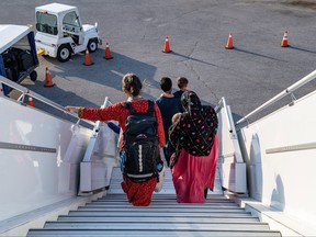 Afghan refugees who supported Canada's mission in Afghanistan arrive at Toronto Pearson International Airport, Aug. 24, 2021.