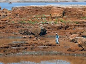 A Tigrayan refugee walks on the banks of the Setit river bordering Ethiopia, at Wad al-Hiliou, a village in the eastern Sudanese state of Kassala, on August 11, 2021. (Photo by ASHRAF SHAZLY/AFP via Getty Images)