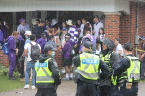 Police officers keep watch on a house party on Broughdale Avenue, near Western University, on Saturday Sept. 25, 2021. (Jonathan Juha/The London Free Press)