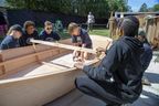 Tyler Groat, 11, ties a keel to a rowboat Friday during a youth ship building project at the Periscope Playhouse in Port Burwell.  The week-long exercise, run by a community organization called Stem2Stern, introduces grade 5-8 students to woodworking skills by crafting boats.  (Derek Ruttan/The London Free Press)