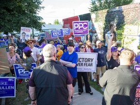 People protest against Prime Minister Justin Trudeau during a campaign stop at the  London Co-Operative Brewing Company in London on Monday. (Derek Ruttan/The London Free Press)