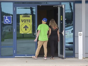 Voters enter the polling station at the Cosgrove Hockey Academy in St. Thomas. (Derek Ruttan/The London Free Press)