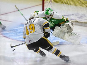 Nolan DeGurse of the Sarnia String breaks in early on London Knights goaltender Brett Brochu during the Knights' first exhibition game of the season -- and the first since the pandemic began -- at Budweiser Gardens in London on Friday Sept. 3, 2021. (Mike Hensen/The London Free Press)