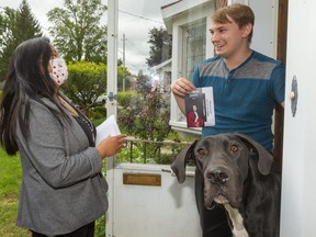 Elizabeth Quinto, the Liberal candidate for Oxford, campaigns at the home of Mitchell Gray in Ingersoll. With Gray is his great dane, Midna. Photograph taken on Thursday September 9, 2021. (Mike Hensen/The London Free Press)