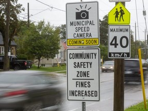 Signs in front of Princess Elizabeth public school on Thompson Road in London warn drivers that photo radar is on the way. Photograph taken on Sept. 22, 2021. (Mike Hensen/The London Free Press)