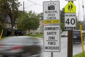 Signs in front of Princess Elizabeth public school on Thompson Road in London warn drivers that photo radar is on the way. Photograph taken on Sept. 22, 2021. (Mike Hensen/The London Free Press)