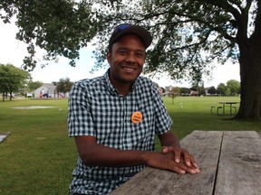 Adam Kilner, the NDP candidate in Sarnia-Lambton, takes a break from the campaign trail at a picnic table in Point Edward's Waterfront Park near the riding's border with Michigan. (Paul Morden/Postmedia Network)