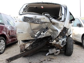 Three vans, heavily damaged when a drunk driver slammed into a Sarnia dealership, sit in the Preferred Towing compound on Monday, March 16, 2020, in Sarnia, Ont. (Terry Bridge/Postmedia Network)