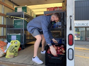 London Food Bank mobile coordinator Matt Story loads up some apples in the agency's truck. The food bank is collecting food and financial contributions during its fall drive. (Free Press file photo)