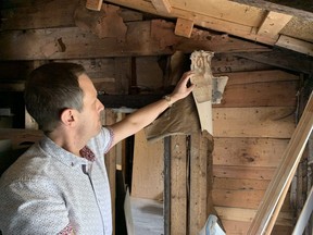 Eric Prendergast shows where stacks of London Advertiser newspaper imprints dating from just after the First World War were found at his home on Weston Street in London. (Paul Vanderhoeven, The London Free Press)