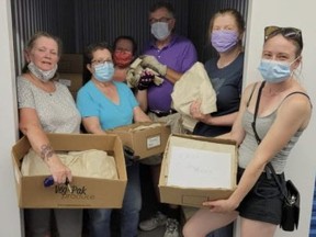 Lori Ashe, left, has organized a Facebook group of people -- London Ontario Reduce, Reuse and Recycle -- who collect and weave plastic shopping bags into mats for the homeless. In July, they accepted a huge shipment of Farm Boy bags as the grocer phased them out. (Photo provided by Lorie Ashe)