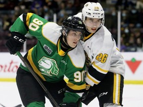 London Knights' Landon Sim (90) and Sarnia Sting's Andrei Malyavin (26) battle in front of the Sting's net in the second period at Progressive Auto Sales Arena in Sarnia, Ont., on Saturday, Oct. 16, 2021. Mark Malone/Chatham Daily News/Postmedia Network