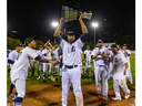 Slugger Cleveland Brownlee holds aloft the Dominico Cup as the London Majors celebrate their first Intercounty Baseball League title since 1975 after an 8-4 Game 5 win Friday night over Toronto at Labatt Park. (Mike Hensen/The London Free Press)