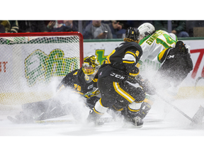 London Knights forward Luke Evangelista pulls off a Forsberg, reaching around Sarnia goalie Benjamin Gaudreau with one hand on his stick to slide the puck into the net, during their game at Budweiser Gardens in London on Friday night. Nolan Dann of the Sting gets back just too late to stop the goal. The Knights won, 5-2. Mike Hensen/The London Free Press