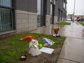 A makeshift memorial for a toddler appears at 400 Lyle Street on Sunday. Police say a young child fell from a balcony of a building near King and Lyle streets Saturday and succumbed to their injuries in hospital. (Derek Ruttan/The London Free Press)