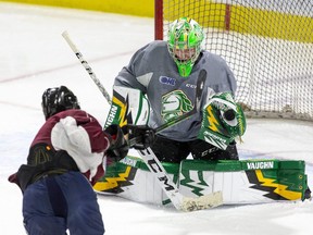London Knights goalie Mathias Onuska makes a save against Knights prospect Mike Levin during a practice at Budweiser Gardens in London. The Knights open the 2021-22 OHL season Friday when they take on the Owen Sound Attack at Budweiser Gardens. (Derek Ruttan/The London Free Press)