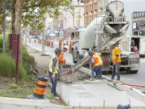 Workers with JNF Concrete build a sidewalk on King Street in London. (Derek Ruttan/The London Free Press file photo)