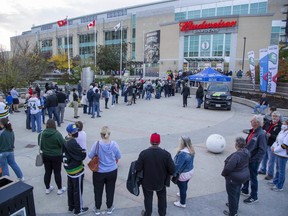 Hundreds of people line up to attend the London Knights season opener at Budweiser Gardens. Entry to the building was slower than usual as ticket takers also had to verify patrons' COVID vaccination status. (Derek Ruttan/The London Free Press)