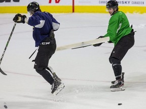 London Knights captain Luke Evangelista jumps out of the way of a shovel-wielding Cody Morgan during practice at Budweiser Gardens in London on Wednesday. Morgan was using the shovel to clear snow from the ice in front of a net. Evangelista is showing signs of being the Knights' new top scorer. (Derek Ruttan/The London Free Press)