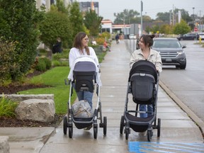 Janelle Cluett with baby boy Bennett, left, and Alainna Schafer with baby girl Maryn do some Christmas shopping at the Westwood Centre on Wonderland Road South. New figures from Statistics Canada show London's birth rate is 1.29 births per woman, a new low. Don Kerr, a demographer and professor at King’s University College who analyzed the figures, said they show young couples are not having kids. Photo taken Friday Oct. 15, 2021. (Derek Ruttan/The London Free Press)