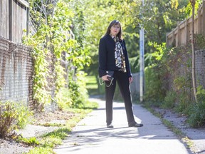 Two decades after she  was beaten, knifed and sexually assaulted on this northeast London pathway, Emilie Paraskevas, 53, has returned seeking closure and new tips to lead police to her attacker.  (Derek Ruttan/The London Free Press)