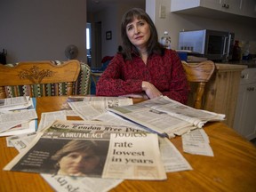 Emilie Paraskevas with newspaper clippings regarding her ordeal in London, Ont. on Thursday October 21, 2021. (Derek Ruttan/The London Free Press)