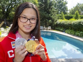 Maggie Mac Neil is photographed with her set of gold, silver, and bronze medals from swimming at the Tokyo Olympics in front of the pool her family installed to teach her to swim in London years ago. (Mike Hensen/The London Free Press file photos)