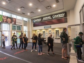 After getting their vaccine status checked outside, fans line up inside Budweiser Gardens on Oct. 1, 2021, for a preseason game between the London Knights and Hamilton Bulldogs. (Mike Hensen/The London Free Press)