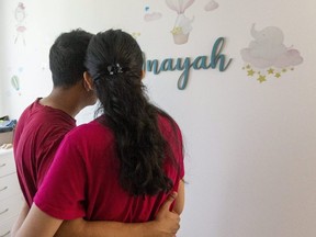 Inayah's father and mother look at the decorations in their daughter's bedroom in their apartment unit at 400 Lyle St. The couple is seeking answers about why the gap in the guardrail of their balcony her father says Inayah fell through is larger than the maximum size set by the Ontario Building Code. “We are in the dark. We just want some answers," her father said. Mike Hensen/The London Free Press