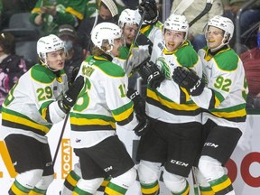 Colton Smith of the Knights, second from right, celebrates his first OHL goal with teammates Brody Crane, left, Sean McGurn, Ben Roger and Jackson Edward, after scoring against the Windsor Spitfires on Friday Oct. 15, 2021, at Budweiser Gardens in London. The league announced Wednesday that Crane is suspended for three games for a boarding major in the Knights game last Friday against Owen Sound. (Mike Hensen/The London Free Press)