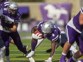 Western Mustangs running back Keon Edwards gets through a big hole for Western's second touchdown against the Windsor Lancers on Oct. 16, 2021, at Western Alumni Stadium. The Mustangs won 54-4 and face the Waterloo Warriors Saturday in Waterloo. (Mike Hensen/The London Free Press)