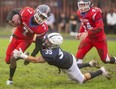 Christian Thomson of Catholic Central high school tackles St. Andre Bessette's Nicholas Myatt in a TVRA London District senior game at CCH on Thursday, Oct. 21, 2021. CCH won 37-7. (Mike Hensen/The London Free Press)